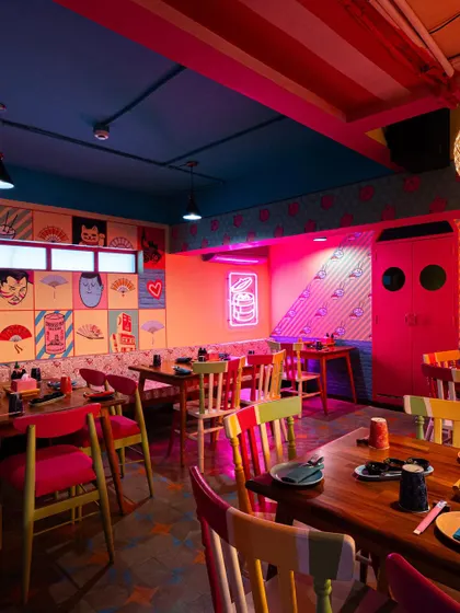 The use of dramatic pink and orange lighting in this section of The Fatty Bao creates a distinct mood. My photography captures how different lighting schemes can define separate zones within a single restaurant.