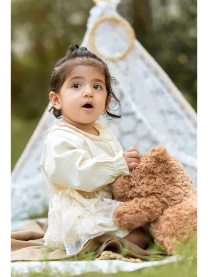 A tender moment between a little girl and her teddy bear. This photo captures the gentle side of Aanshi's personality during her first birthday shoot.