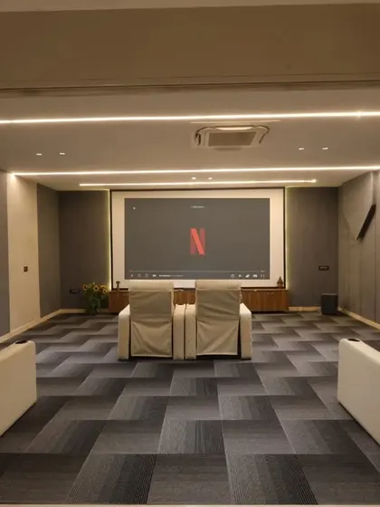 A view from the lounge into the home theater, showcasing the inviting and luxurious setup ready for a movie night.