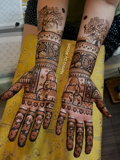 A story-telling mehendi with a tree of life, stacked elephants, and paisley patterns, creating a very organic and traditional feel.