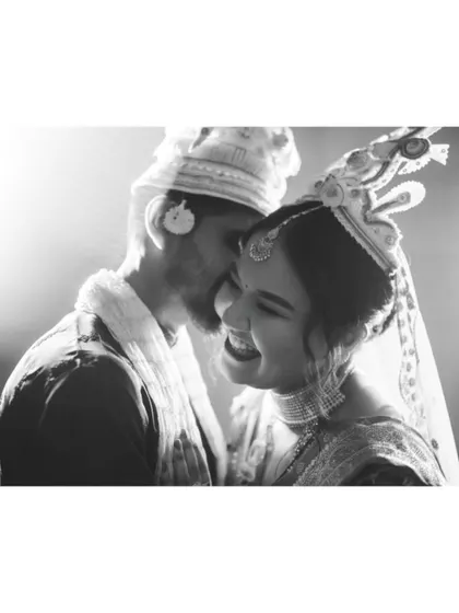 A beautiful black and white photo capturing a moment of shared laughter between the Bengali couple.