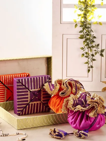 This packing set features vibrant potli bags and gift boxes in rich jewel tones like purple and orange. It's a great option for organizing smaller gifts within a larger trousseau, adding a pop of color and traditional flair.