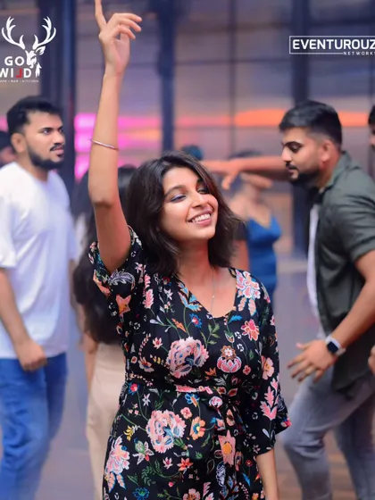 Dancing my heart out at an event. I'm wearing a simple but elegant floral print dress that's perfect for moving around.