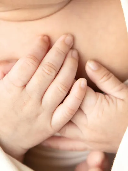Capturing the delicate details of a newborn's tiny, intertwined fingers. These macro shots are a beautiful way to remember how small they once were.