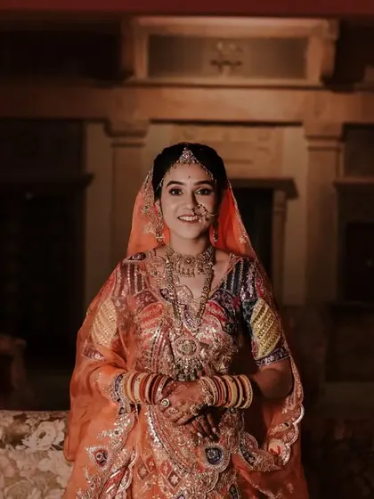 A beautiful, smiling portrait of the bride in her colorful Rajasthani-style wedding outfit.