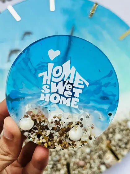 A cute 3-inch ocean-themed fridge magnet that says 'Home Sweet Home'.