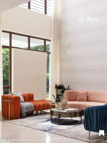 A double-height living room from 'A Walk in the Clouds', featuring a mix of colorful, contemporary sofas against a textured wallpaper. The grand scale of the space is balanced by the soft, inviting furniture.