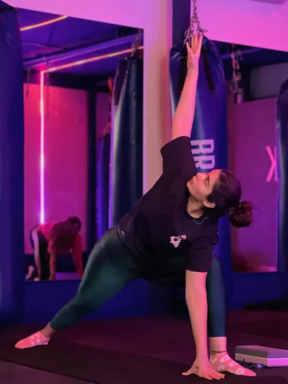 Finding a moment of calm and strength. Our studio's atmosphere, with its unique lighting, helps you focus and connect with your body during a yoga flow.