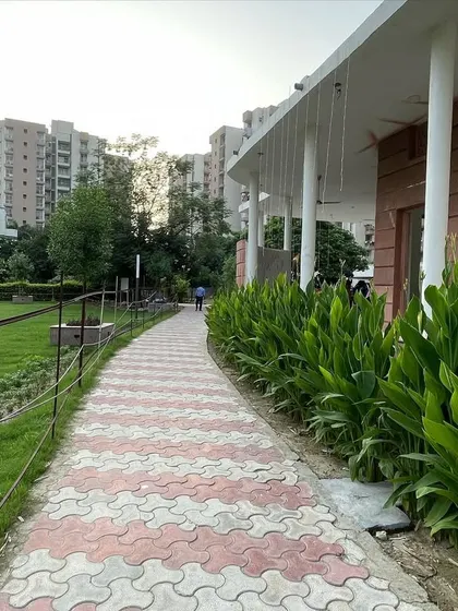 A curved walkway lined with peace lily plants guides residents through the landscaped area. Integrating hardscape elements like paths with softscape elements like plants is key to creating a functional and beautiful garden.