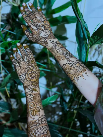 An artistic shot of the floral henna, showing the design on both arms from a unique angle.