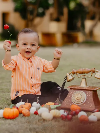 Pure happiness! This little boy celebrates his first birthday outdoors with a vintage telephone and other fun props.