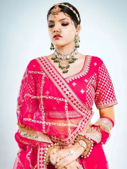 This pose highlights the beautiful check pattern on the blouse and the delicate work on the dupatta.