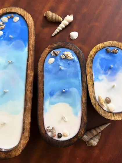 My exquisite wooden boat-shaped scented candles. These are themed to look like a beach, complete with real seashells. I have them in three different sizes.