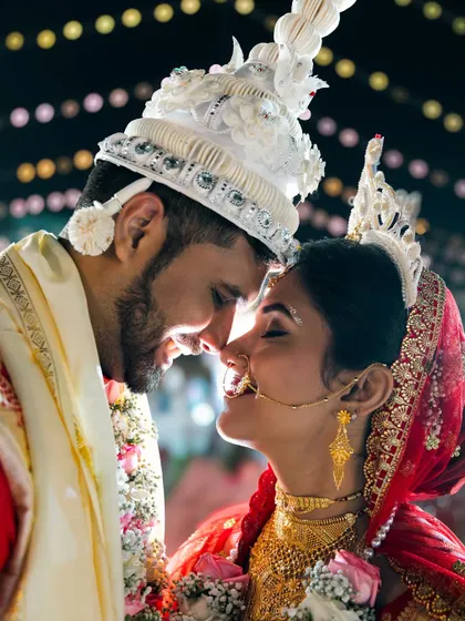 This is the magic we live for. The quiet moment between a bride and groom, full of love and anticipation, captured during a beautiful Bengali wedding ceremony.