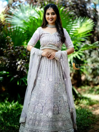 A full-length standing portrait of the lavender lehenga, showing its complete, elegant look.