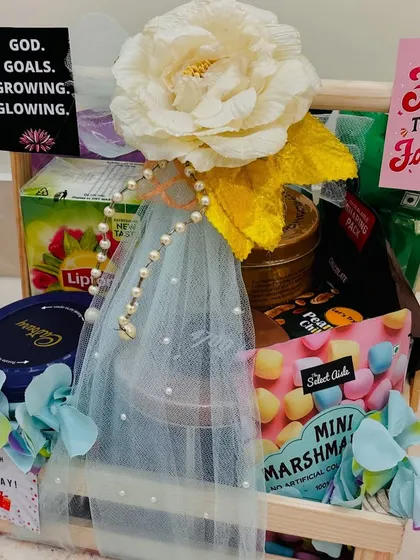 A different angle of the 50th birthday treat hamper, showing the variety of snacks and the lovely floral and pearl decorations.