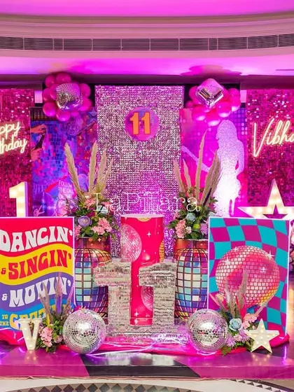 A full view of the incredible disco stage, complete with prop guitars, speakers, and a dazzling array of lights and colors.