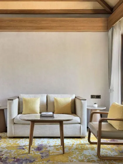 Our suites include a comfortable and stylish living area, furnished with a plush sofa and armchair. It is the perfect corner to read a book or simply relax after a day of exploring.
