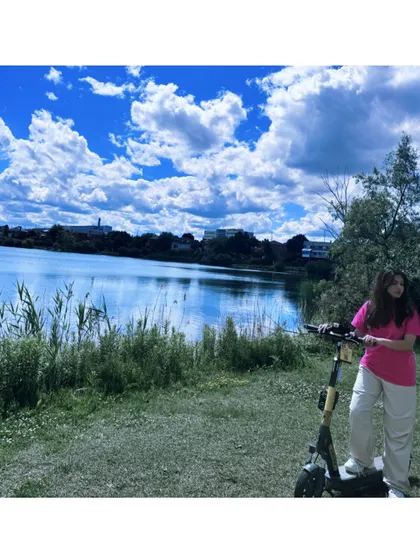Taking a break with an electric scooter by the lake on a perfect summer day.
