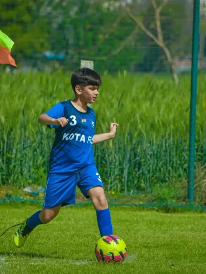 A player gets ready to take a corner kick, a critical set-piece opportunity in any football match.