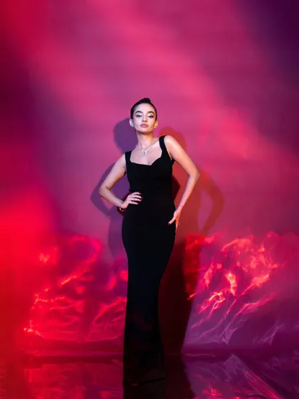 The full silhouette of the elegant black fishtail gown. My goal is always to choose outfits that flatter the client's form and create a powerful visual impact.