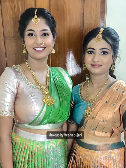 Sisters Swathi and her sibling, looking gorgeous in coordinated half-saree outfits.