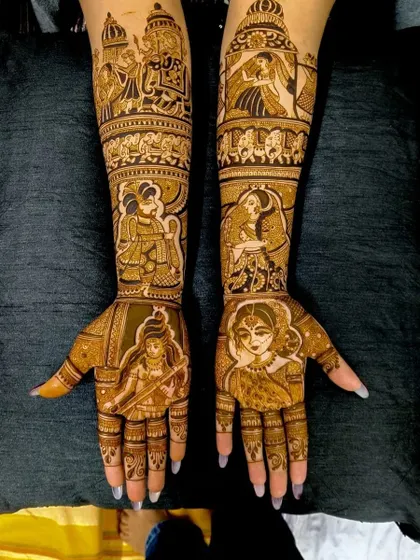A very detailed design featuring multiple figures, including the bride, groom, and deities, telling a story of love and blessings.