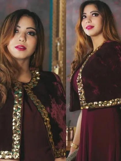 This modern Indo-Western outfit features a rich maroon velvet cape with striking gold embellishments. It's a perfect choice for a cocktail party, sangeet, or a stylish wedding guest look.