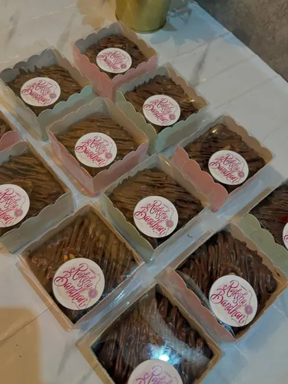 My brownie boxes ready for Rakshabandhan, each with a custom "Rakhi Bandhan" sticker.