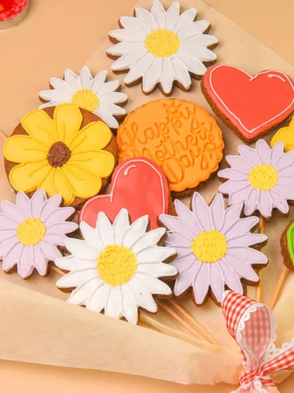 A close-up of the intricately decorated cookies in the bouquet. This shot highlights the artistry and detail of the baked goods.
