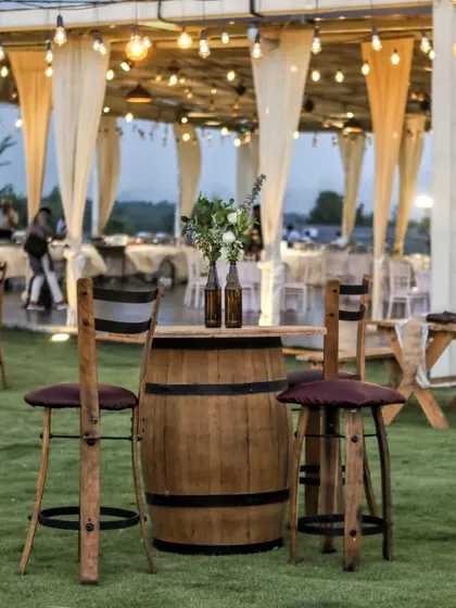 We believe in creative and sustainable decor. For this rustic Mehendi, we upcycled beer bottles into charming flower vases and used a boat as a unique centerpiece, all under a canopy of poetic string lights.