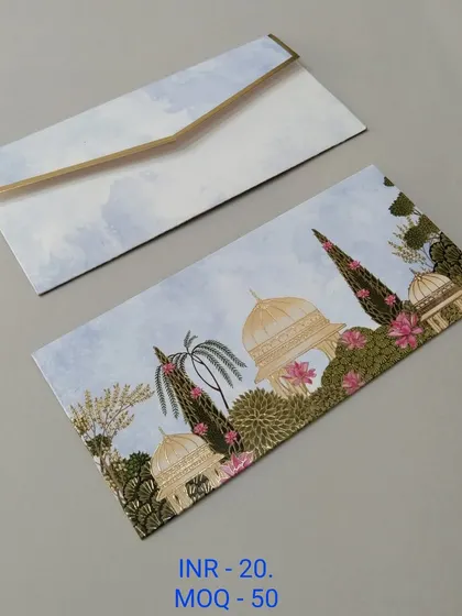 A soft pink envelope with faint silhouettes of palace domes and hanging temple bells in gold foil. This design is perfect for those who want a traditional yet understated look.