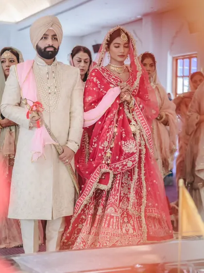 The couple performs the Laavan Pheras, a central part of the Sikh wedding. This shot captures the movement and tradition of the ceremony.