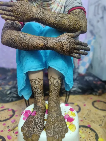 The complete bridal look, with detailed mehndi from fingertips to elbows and covering the feet. I love creating a design that flows beautifully for the entire wedding ceremony.