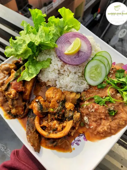 A rich and diverse plate featuring sareng (boal fish), yongchak eromba (stink bean mash), and a local chicken curry.