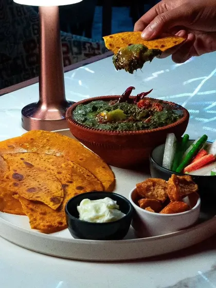 A complete Punjabi meal experience. Our Sarson ka Saag is served with Makki ki Roti, white butter, and jaggery, just as it should be.