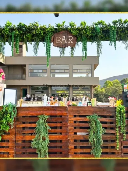 A bar that blends with nature. This rustic bar is built from wooden pallets and adorned with lush greenery, creating a beautiful, organic look for an outdoor event.