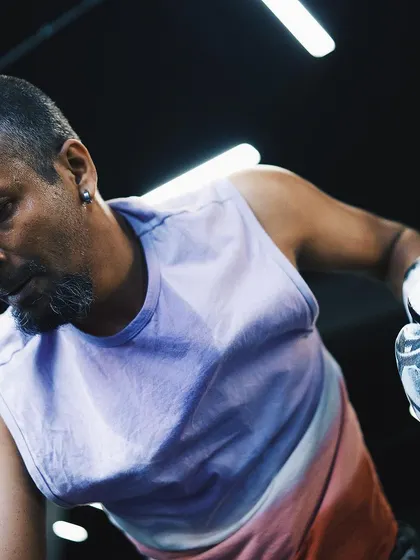 The focus of a fighter. This shot captures the intensity and concentration required during a heavy bag workout.