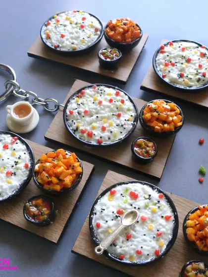 A collection of curd rice miniatures, some as keychains and some as platters.