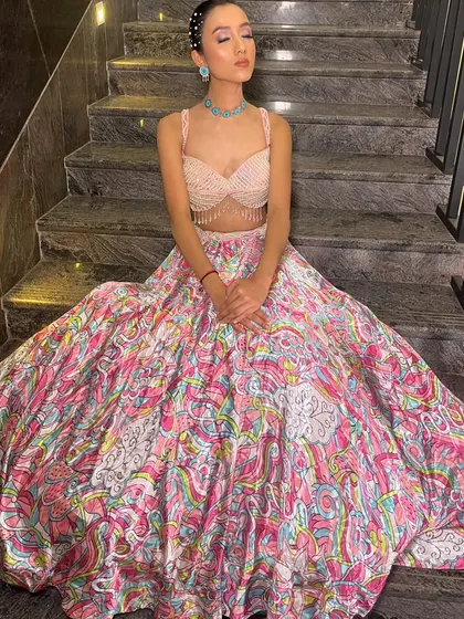 A full view of the colorful printed lehenga, showing off its wide flare and vibrant pattern.
