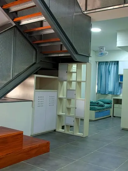 A six-student hostel module with a common social space and a mezzanine level, designed to foster interaction and a sense of community.