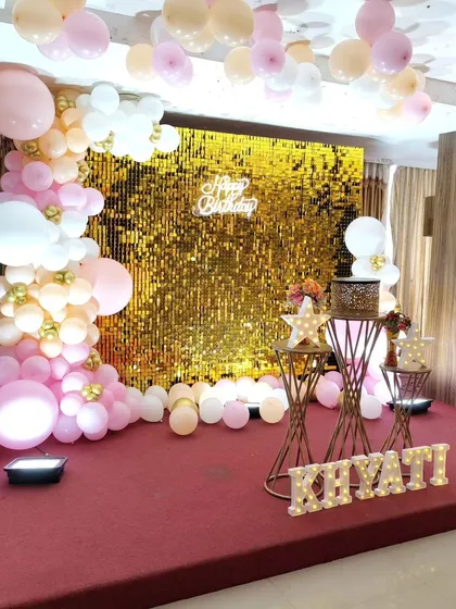 A glamorous setup with a gold sequin backdrop, perfect for creating a dazzling photo corner or main stage.
