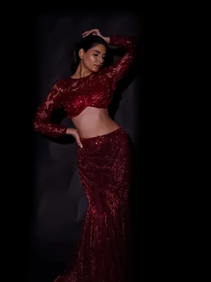 Using shadows to sculpt the body and highlight the silhouette of this stunning red sequined gown. The low-key lighting creates a sense of drama and intimacy.