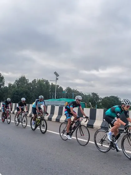 The peloton from a distance, showing the race unfolding against a wide, open landscape.
