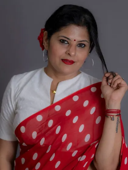 A playful pose in the red polka dot saree, showing how fashion can be expressive and fun.