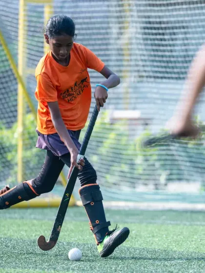 A young player demonstrates excellent form and control while dribbling the ball. Our coaching focuses on building a strong foundation of fundamental hockey skills from the very beginning.