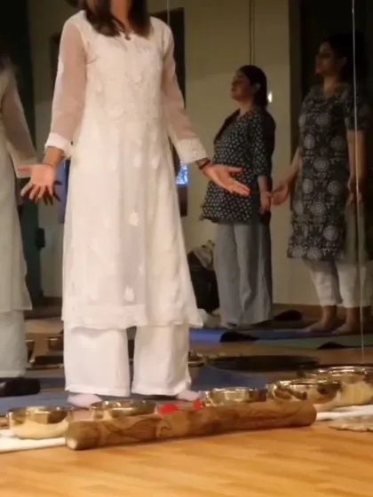 A practitioner leading a group in a healing circle, with singing bowls ready to create a soundscape for relaxation.
