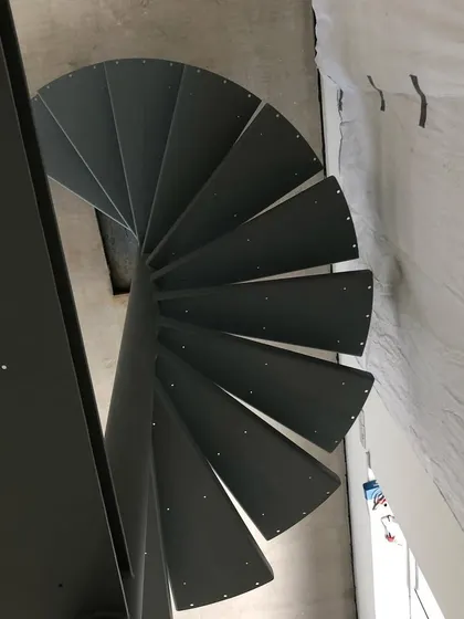 An abstract view looking up the core of the steel spiral. This shows the geometry and precision required in the fabrication process.