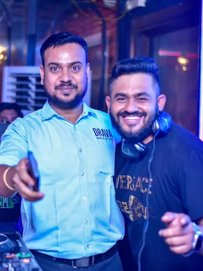 Posing with a fan or staff member. I always make time for the people who support me.