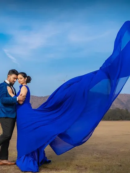 A duplicate image of the couple's pre-wedding shoot with the blue trail gown.